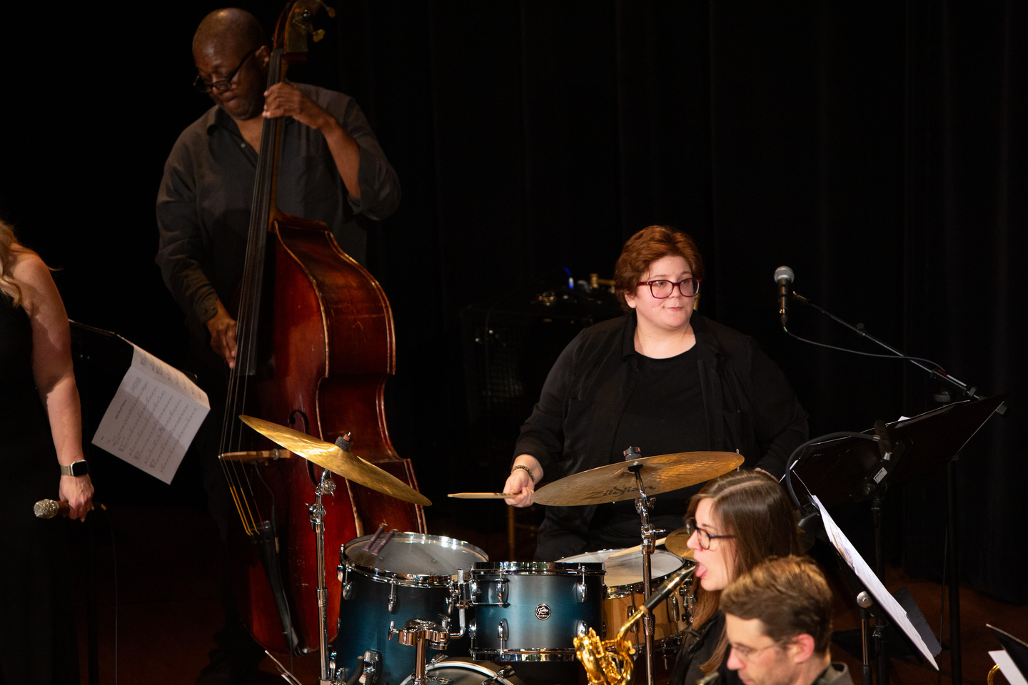 Bandleader Chelsea Hughey on drums beside the upright bassist, mid-song.